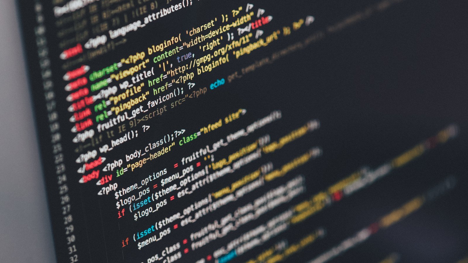Close-up of a dark computer screen showing PHP and WordPress theme code