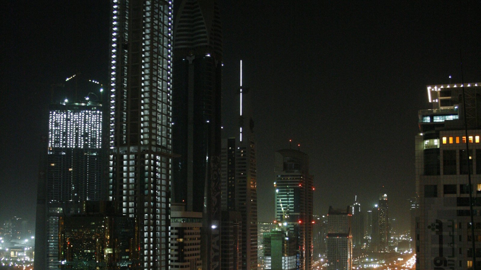 Sheikh Zayed Road in Dubai at night, with lit towers along the highway