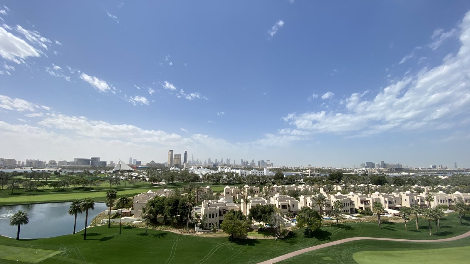 Villas beside the Dubai Creek golf course with the skyline beyond