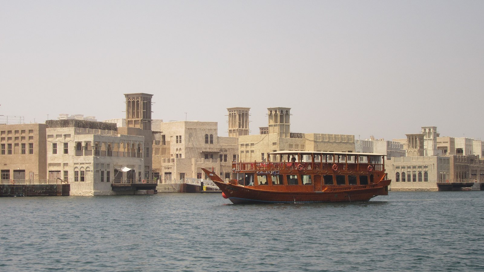 A dhow cruise boat on Dubai Creek beside Al Seef